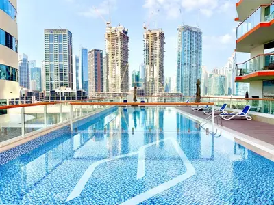 a swimming pool with a view of a city skyline at Mahenti - 1BR - Stunning Lake & Burj Khalifa Views in Dubai