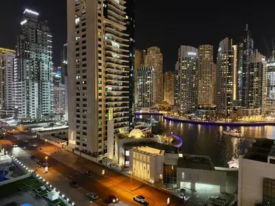 a city skyline at night with a river and buildings at Mahenti - 1BR in Dubai Marina - Near Metro & Tram in Dubai