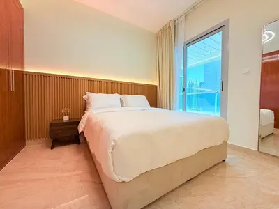 a bedroom with a large bed and a large window at Mahenti - 1BR in Dubai Marina - Near Metro & Tram in Dubai