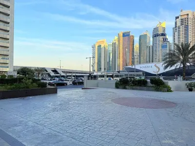 a city skyline with tall buildings and a parking lot at Mahenti - 1BR in Dubai Marina - Near Metro & Tram in Dubai