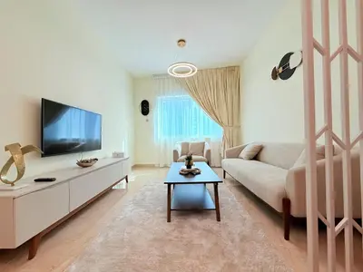 a living room with a couch and a tv at Mahenti - 1BR in Dubai Marina - Near Metro & Tram in Dubai