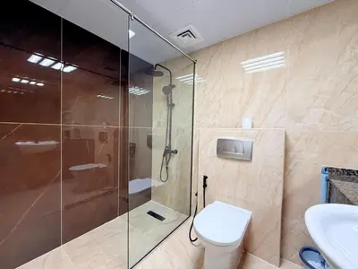 a bathroom with a shower and a toilet and a sink at Mahenti - 1BR in Dubai Marina - Near Metro & Tram in Dubai