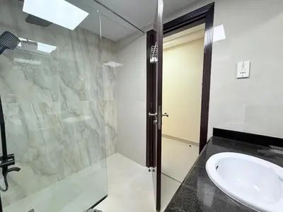 a bathroom with a glass shower and a sink at Mahenti - Bright & Cozy Studio Metro Accessible in Dubai