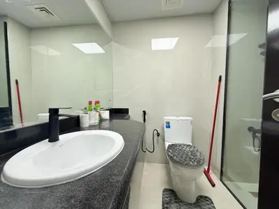 a bathroom with a sink and a toilet at Mahenti - Bright & Cozy Studio Metro Accessible in Dubai