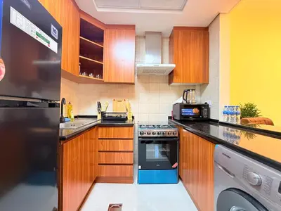 a kitchen with a stove and a dishwasher at Mahenti - Bright & Cozy Studio Metro Accessible in Dubai