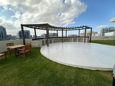 a pavilion on the roof of a building with a table and chairs at Mahenti - Jewelz · With balcony easy to pool & gym in Dubai