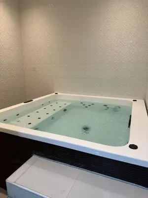 a bath tub filled with water in a bathroom at Mahenti - Jewelz · With balcony easy to pool & gym in Dubai