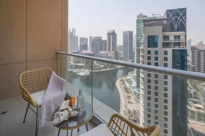 a balcony with a table and chairs and a view of a city at Frank Porter - Aurora Tower, Dubai Marina in Dubai