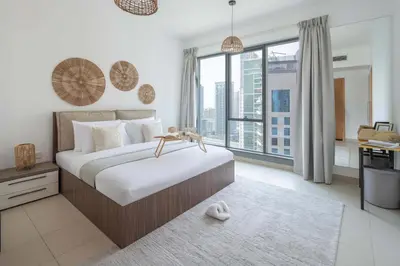 a bedroom with a large bed and a large window at Frank Porter - Aurora Tower, Dubai Marina in Dubai