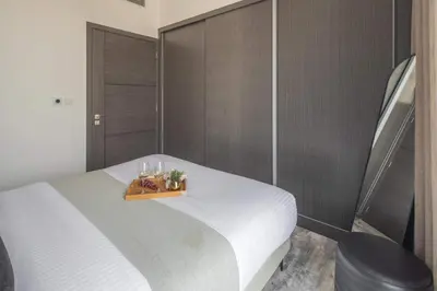 a bedroom with a white bed with a tray on it at Frank Porter - The Paragon in Dubai