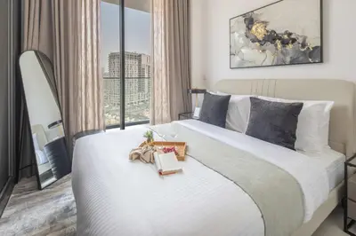 a bedroom with a large white bed with a window at Frank Porter - The Paragon in Dubai