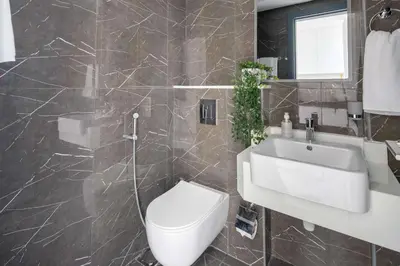 a bathroom with a white toilet and a sink at Frank Porter - Samana Golf Avenue in Dubai