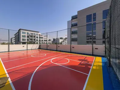 a basketball court on a building with buildings in the background at Frank Porter - Samana Golf Avenue in Dubai