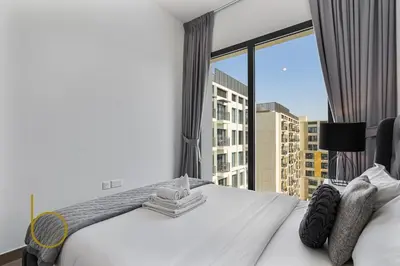 a hotel room with a bed and a large window at Bookable 1 Bed Liva Tower with Pool & Garden in Dubai