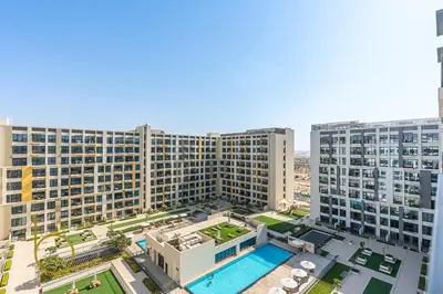 an aerial view of a large building with a pool at Bookable 1 Bed Liva Tower with Pool & Garden in Dubai