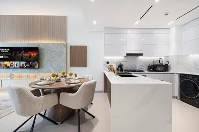 a kitchen with a table and chairs in a kitchen at Deluxe Binghatti JVC Suites by Hostiva - City View in Dubai
