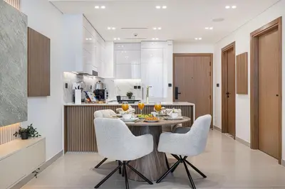 a kitchen and dining room with a table and chairs at Deluxe Binghatti JVC Suites by Hostiva - City View in Dubai