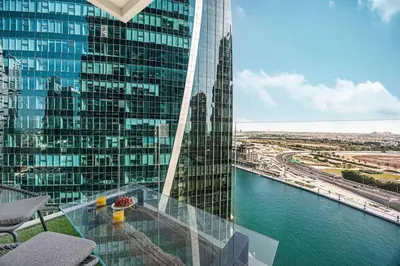 a glass balcony with a view of a tall building at Mahogany 20 - 1BR 4PAX - Infinity Pool & Spacious in Dubai