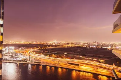 a view of a city at night with traffic at Mahogany 20 - 1BR 4PAX - Infinity Pool & Spacious in Dubai