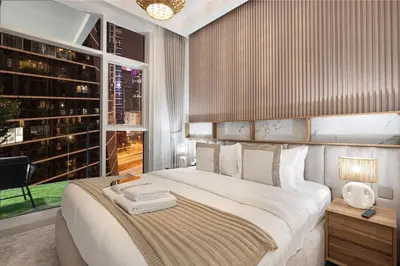 a bedroom with a large bed and a large window at Mahogany 19 - 2BR 6PAX - Infinity Pool Stylish Flat in Dubai