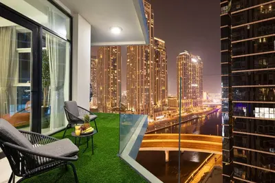 a balcony with chairs and a view of a city at Mahogany 19 - 2BR 6PAX - Infinity Pool Stylish Flat in Dubai