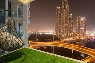 a view of a city at night from a building at Mahogany 19 - 2BR 6PAX - Infinity Pool Stylish Flat in Dubai