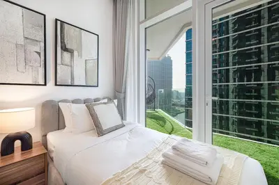 a bedroom with a bed and a large window at Mahogany 19 - 2BR 6PAX - Infinity Pool Stylish Flat in Dubai