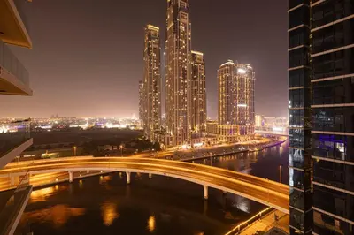 a city at night with a bridge and buildings at Mahogany 19 - 2BR 6PAX - Infinity Pool Stylish Flat in Dubai
