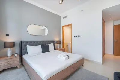 a bedroom with a large bed and a mirror at StayShort - Premium 2BR in Dubai Marina - Sleeps 4 in Dubai