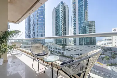 a balcony with chairs and a view of the city at StayShort - Premium 2BR in Dubai Marina - Sleeps 4 in Dubai