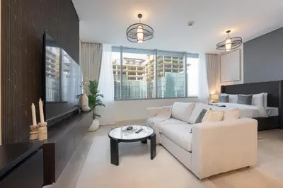 a living room with a couch and a bed at StayShort - Extravagant Studio in DIFC with Skyline Views in Dubai