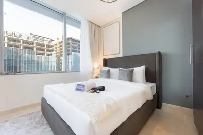 a bedroom with a large bed with a large window at StayShort - Extravagant Studio in DIFC with Skyline Views in Dubai