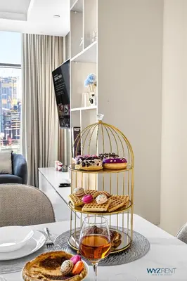 a plate of pastries in a bird cage on a table at Spacious and Luxurious 2 BD in Downtown Sleeps 8 with Maid Room in Dubai