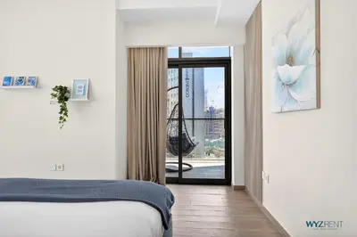 a bedroom with a bed and a view of a city at Spacious and Luxurious 2 BD in Downtown Sleeps 8 with Maid Room in Dubai