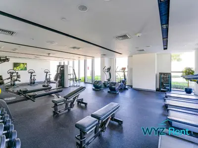 a gym with treadmills and machines in a room at Iconic 4BR with Burj & Fountain Views Boulevard Point in Dubai