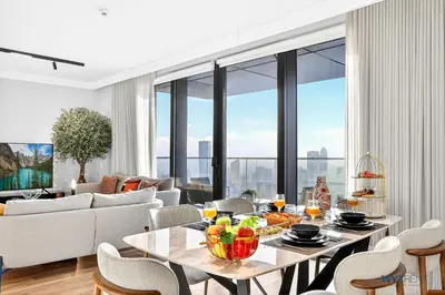 a living room with a table with fruit on it at Iconic 4BR with Burj & Fountain Views Boulevard Point in Dubai