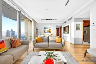 a living room with a couch and a table at Iconic 4BR with Burj & Fountain Views Boulevard Point in Dubai
