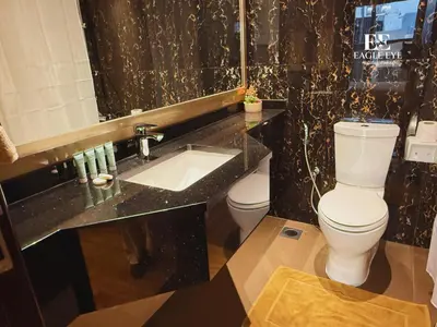 a bathroom with a toilet and a sink at Spacious 1 Bed with Burj Khalifa View accommodates 3 or 4 in Dubai