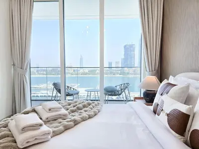 a bedroom with a bed with a view of the water at Venduras- 2BR Retreat , Beach Access , Emaar Beachfront in Dubai
