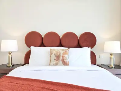 a bedroom with a large bed with two lamps at Venduras- 2BR Retreat , Beach Access , Emaar Beachfront in Dubai