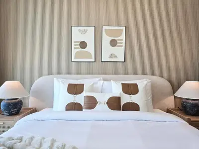 a bedroom with a white bed with two lamps at Venduras- 2BR Retreat , Beach Access , Emaar Beachfront in Dubai
