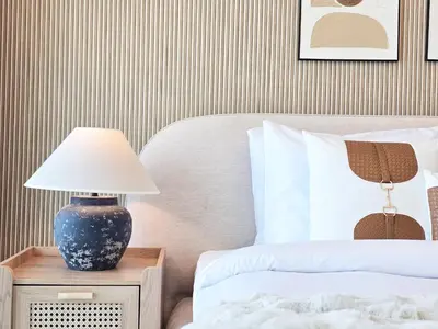 a bedroom with a bed and a lamp on a night stand at Venduras- 2BR Retreat , Beach Access , Emaar Beachfront in Dubai