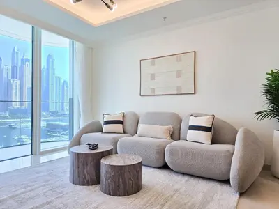a living room with a couch and a table at Venduras- 2BR Retreat , Beach Access , Emaar Beachfront in Dubai