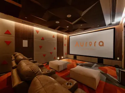 a theater room with a couch and a large screen at Downtown Luxury 2 Bedroom Apartment with Iconic Burj Khalifa Views, Rooftop Pool, Movie Room, Squash Court, and Kids Club in Dubai
