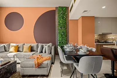 a living room with a couch and a table at Downtown Luxury 2 Bedroom Apartment with Iconic Burj Khalifa Views, Rooftop Pool, Movie Room, Squash Court, and Kids Club in Dubai
