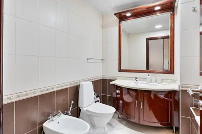 a bathroom with a toilet and a sink and a mirror at Modern 2 Bed with Waterfront Views, Gym & Pool in Dubai