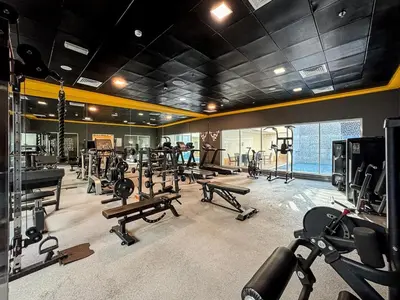 a gym with treadmills and machines in a room at Modern 2 Bed with Waterfront Views, Gym & Pool in Dubai