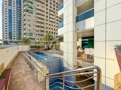 a swimming pool on the roof of a building at Modern 2 Bed with Waterfront Views, Gym & Pool in Dubai