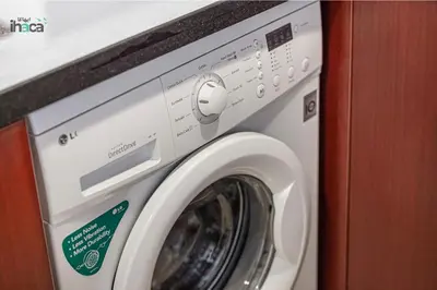 a white washing machine sitting in a room at 1 Br Boho Beach Ain Full Sea View JBR 1 min in Dubai