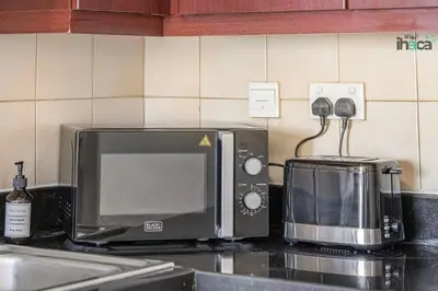 a microwave sitting on top of a kitchen counter at 1 Br Boho Beach Ain Full Sea View JBR 1 min in Dubai
